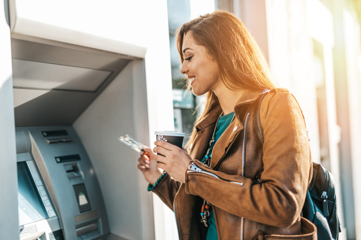 A women inserting her card into an ATM